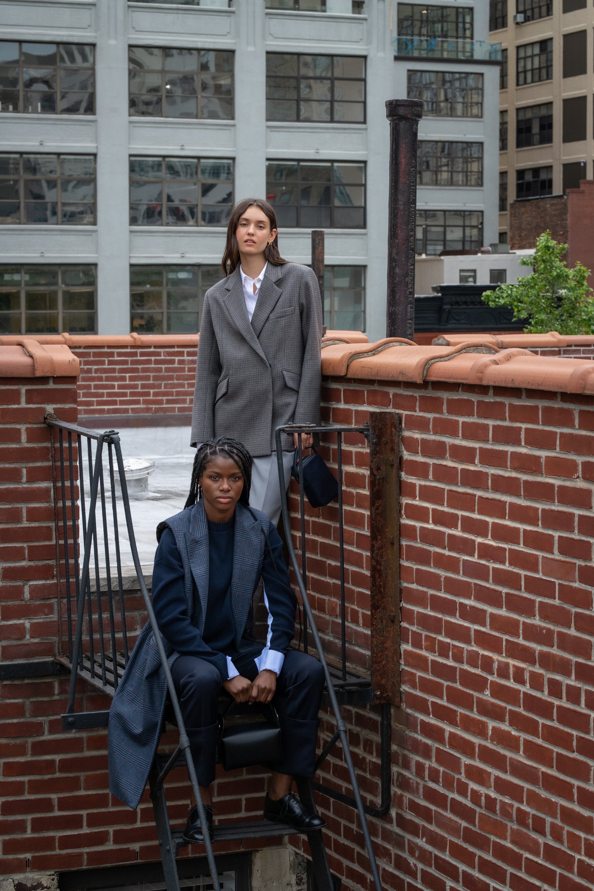 WE-AR4 models standing on metal staircase outside wearing latest products from Capsule 007: Fire